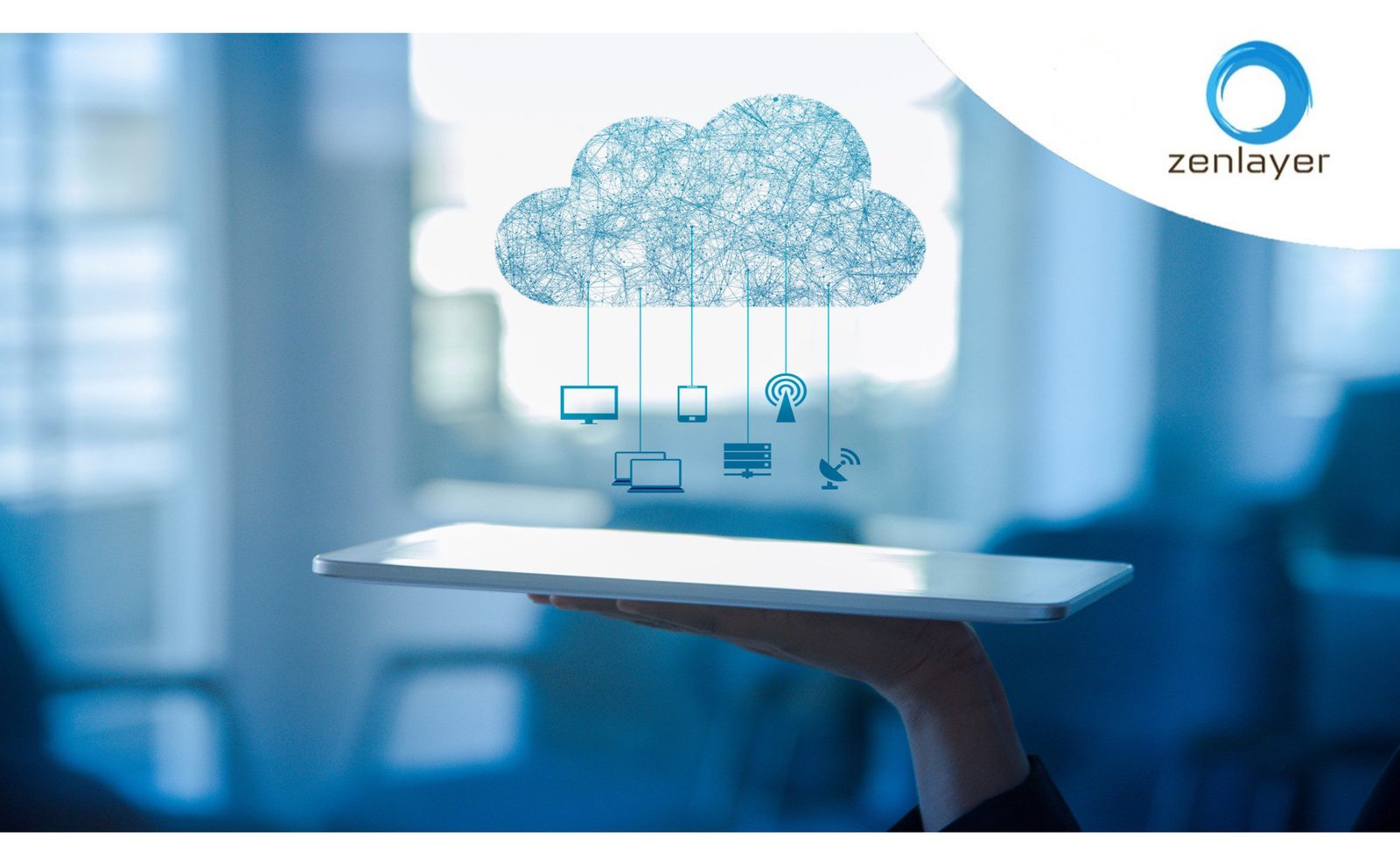 A hand holds a digital tablet with a holographic cloud above it. Connected to the cloud are icons representing various devices like a computer, smartphone, and server. The background is a blurred office setting, and there is a Zenlayer logo in the corner.